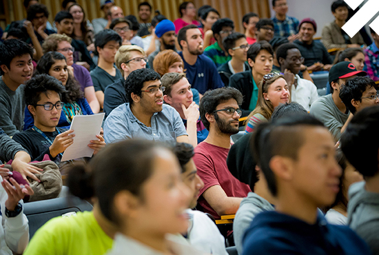 lots of students engaged by a speaker in a lecture hall